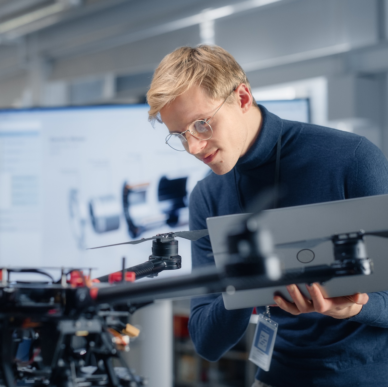 Kritis Begleitschutz besonderes Gut Junger Ingenieur arbeitet an einer Drohne.